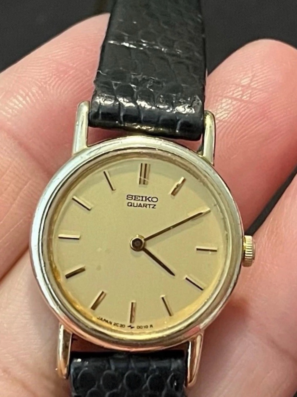 Seiko Quartz Vintage Watch with a champagne gold dial and a black leather band